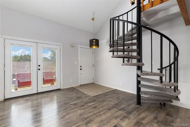 a view of entryway with wooden floor and stairs