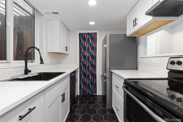 a kitchen with a sink and a stove top oven