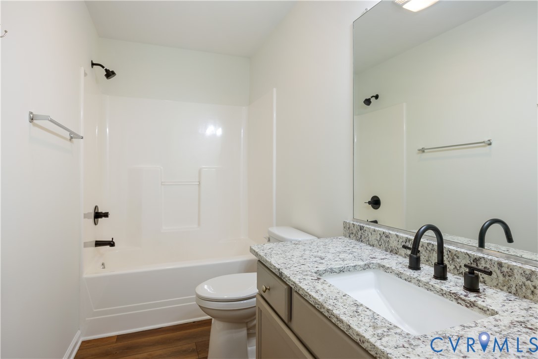5 Walters Way Bumpass, VA 23024 - Photo 17 of 28 a bathroom with a granite countertop sink toilet and shower
