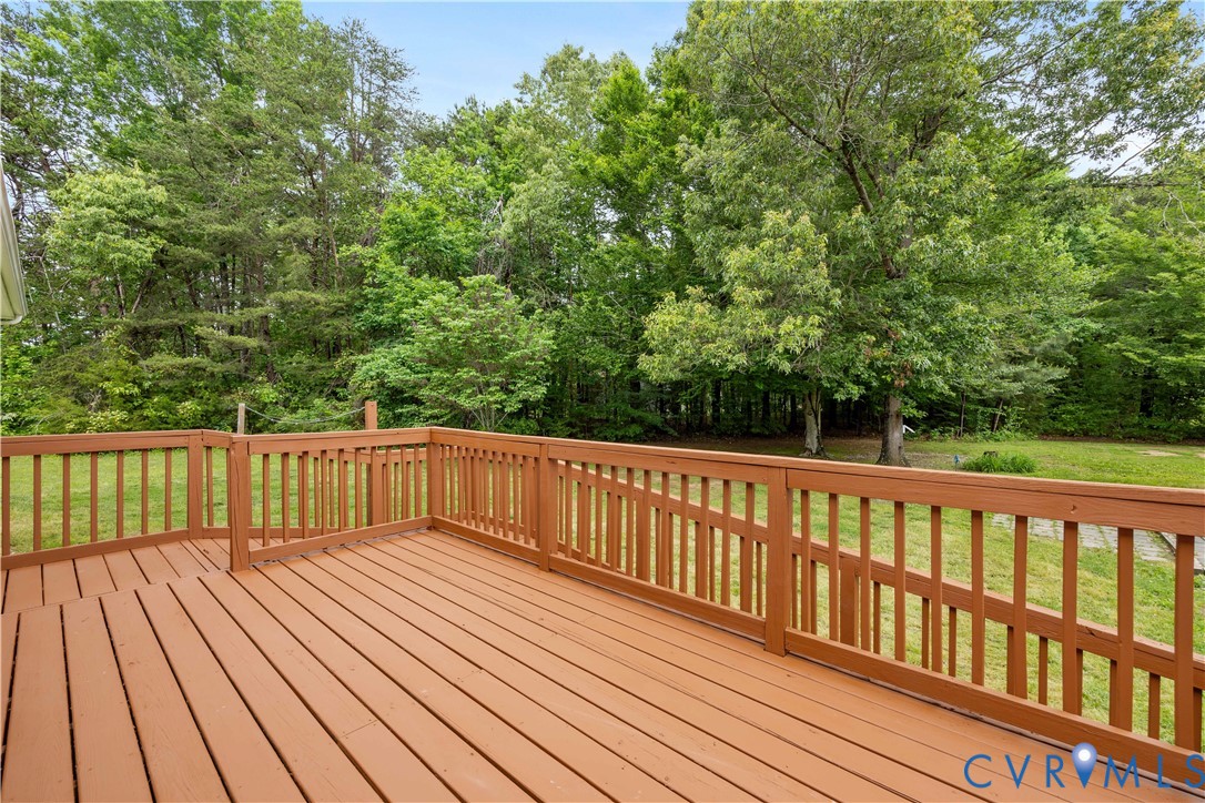 5 Walters Way Bumpass, VA 23024 - Photo 21 of 28 a balcony with wooden floor and trees in the back