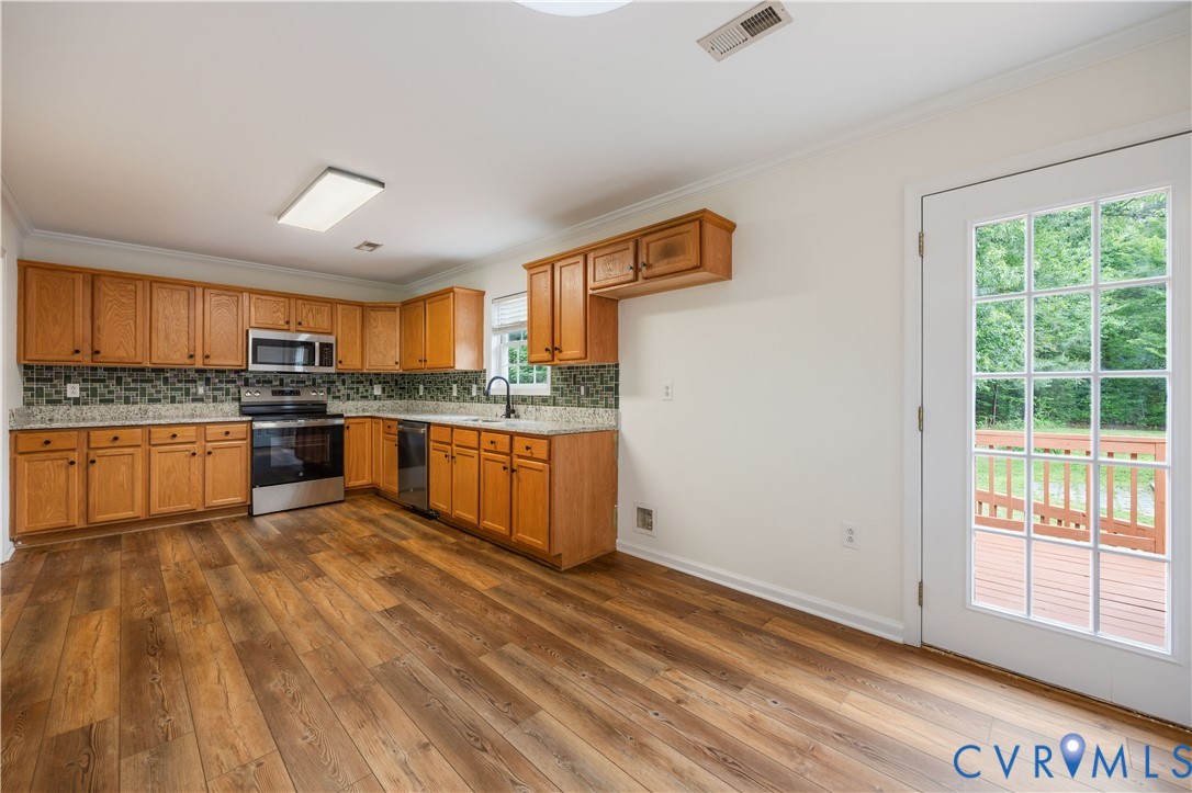 5 Walters Way Bumpass, VA 23024 - Photo 9 of 28 a kitchen with stainless steel appliances granite countertop a stove a sink dishwasher and a refrigerator