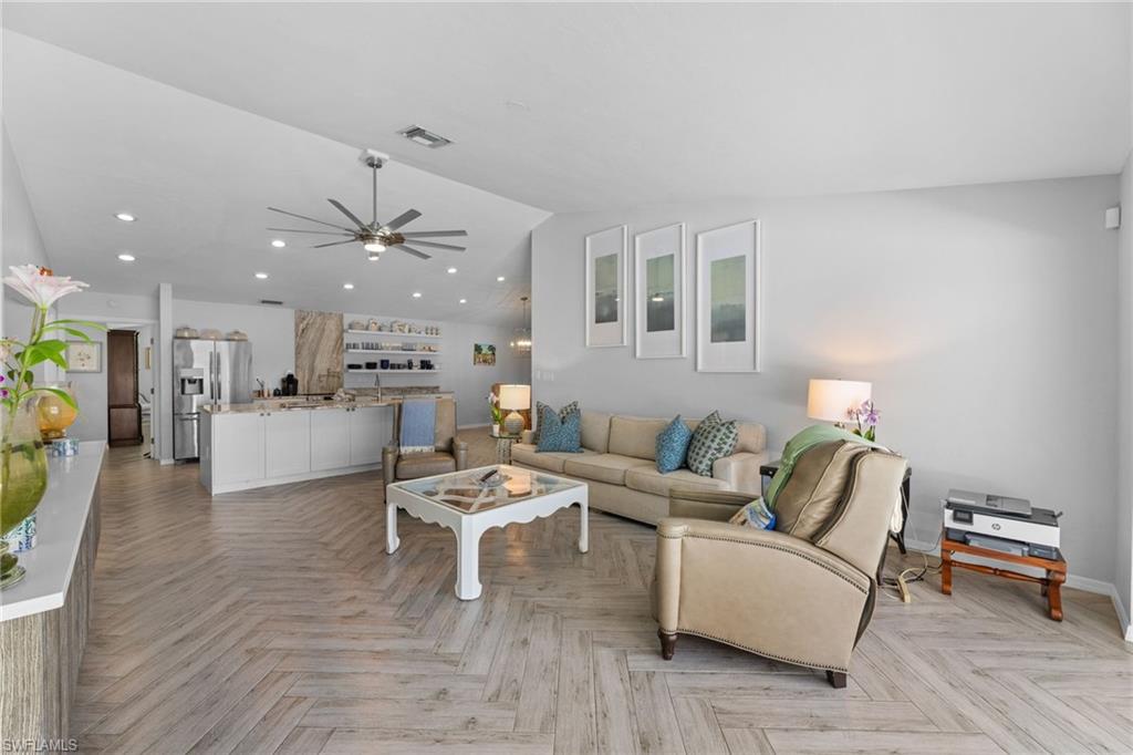 2467 Pinewoods Circle, Unit 3 Naples, FL 34105 - Photo 17 of 33 Living room with lofted ceiling, ceiling fan, and light parquet flooring