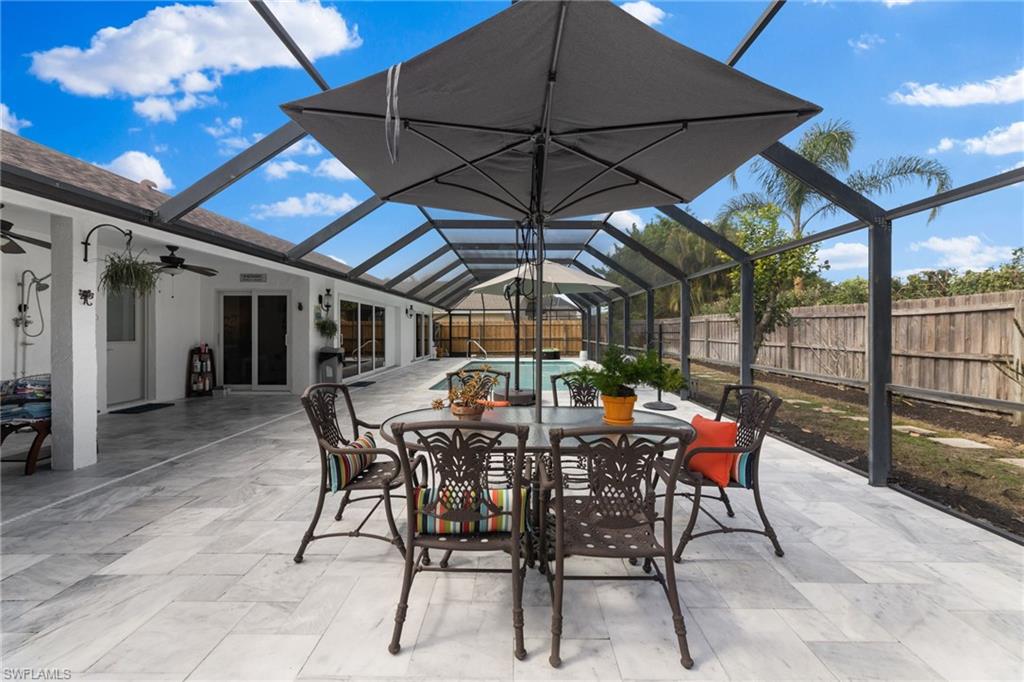 2467 Pinewoods Circle, Unit 3 Naples, FL 34105 - Photo 21 of 33 View of patio with ceiling fan and glass enclosure