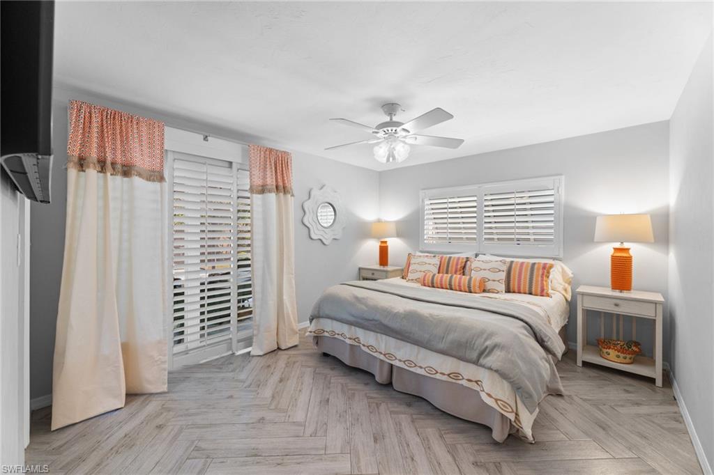2467 Pinewoods Circle, Unit 3 Naples, FL 34105 - Photo 31 of 33 Bedroom featuring light parquet flooring and ceiling fan