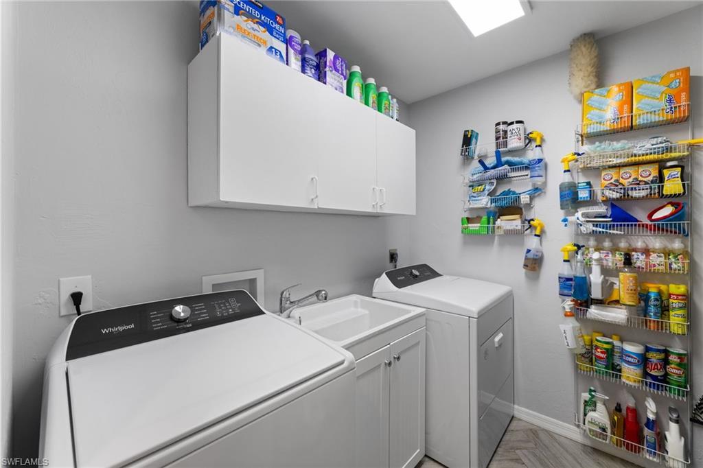2467 Pinewoods Circle, Unit 3 Naples, FL 34105 - Photo 33 of 33 Laundry room with cabinets, washer and dryer, sink, and light parquet flooring