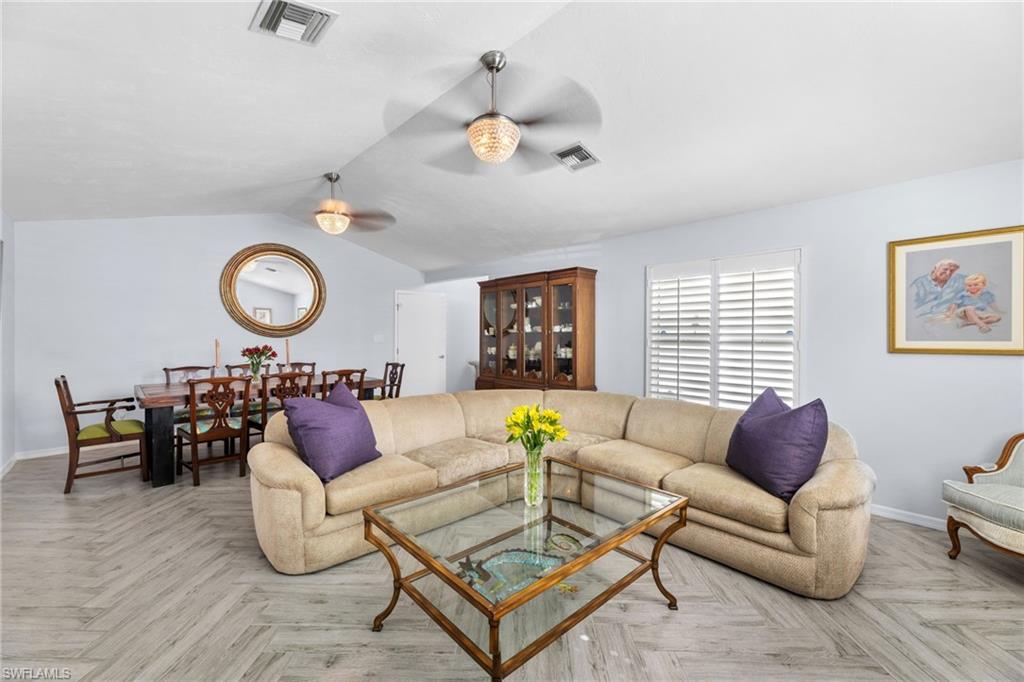 2467 Pinewoods Circle, Unit 3 Naples, FL 34105 - Photo 5 of 33 Living room featuring ceiling fan, light parquet floors, and lofted ceiling