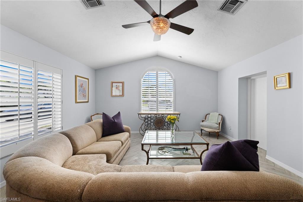 2467 Pinewoods Circle, Unit 3 Naples, FL 34105 - Photo 6 of 33 Living room with lofted ceiling and ceiling fan