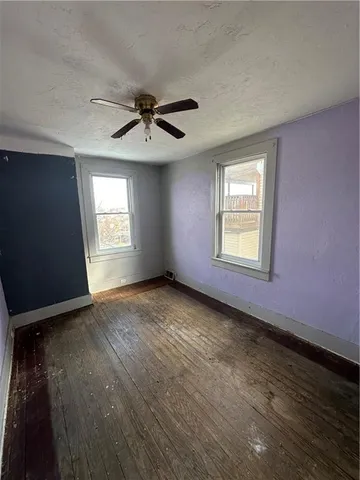a view of empty room with ceiling fan