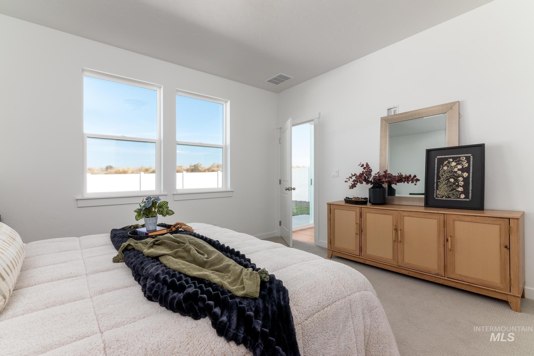 8521 West Stillmore Street Star, ID 83669 - Photo 6 of 7 Bedroom featuring light carpet and multiple windows