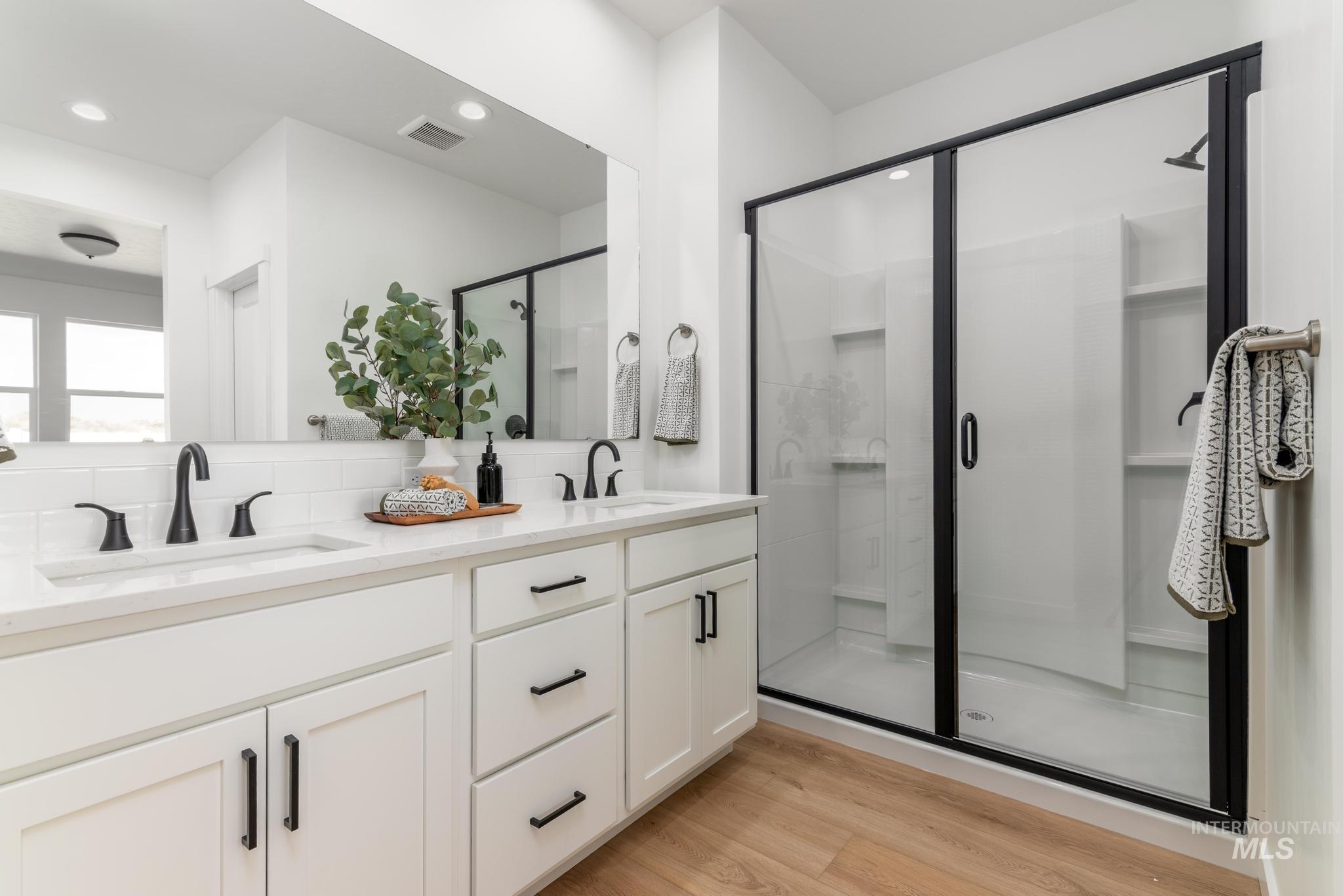 8521 West Stillmore Street Star, ID 83669 - Photo 7 of 7 Bathroom with light wood-type flooring, a stall shower, and double vanity