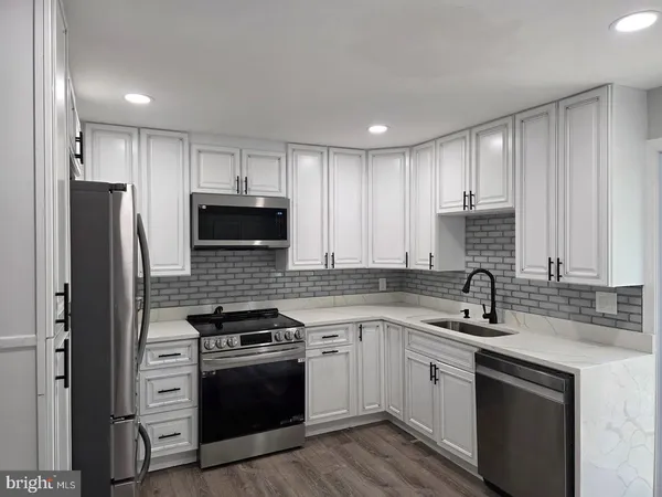 a kitchen with a sink stove and refrigerator