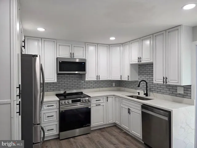 a kitchen with a sink stove and refrigerator