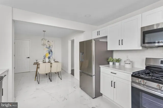 a kitchen with cabinets and window