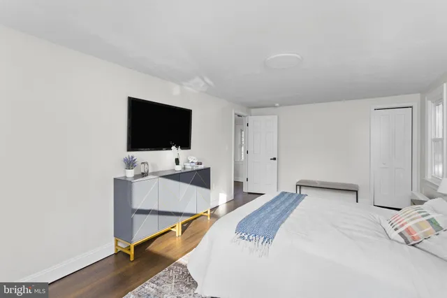 an empty room with wooden floor and a window