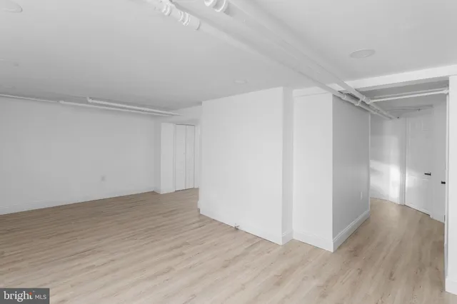 a view of hallway with wooden floor