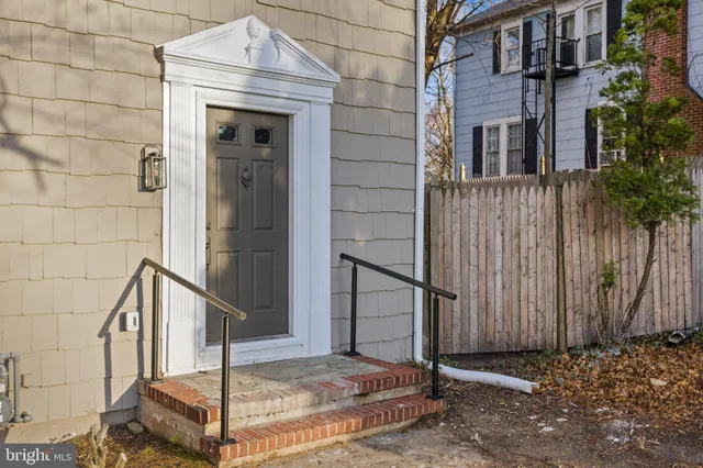 a living room with furniture a rug and a window