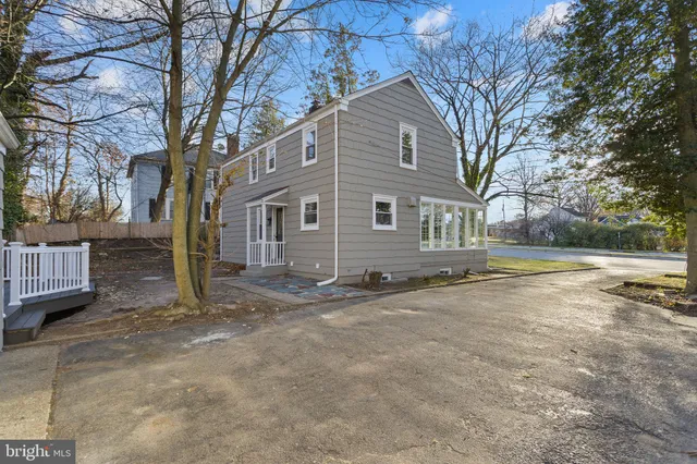 front view of a house with a large trees