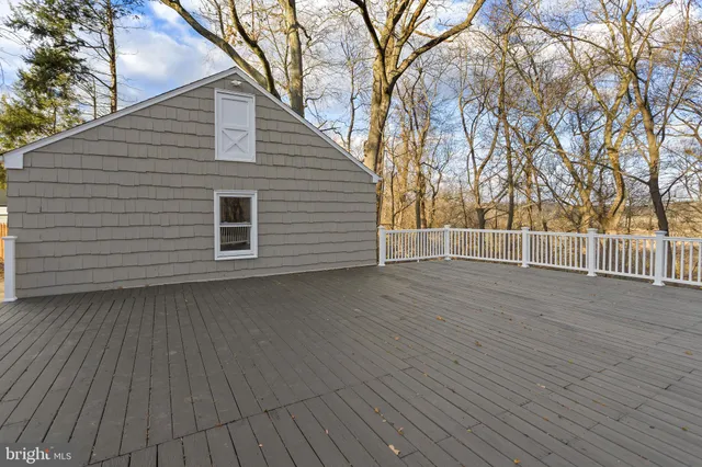 a view of a house with a wooden fence