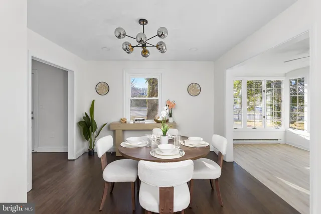 a view of a room with a large window and wooden floor