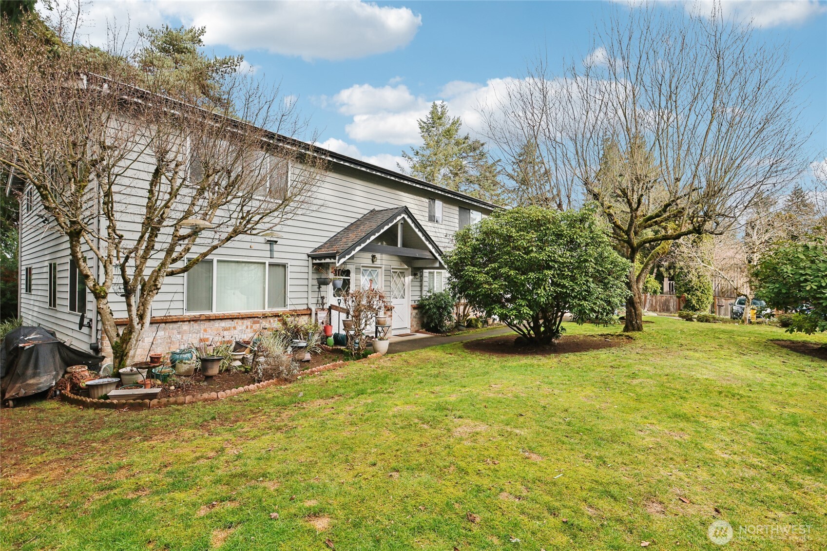 7909 218th Street Southwest, Unit 4 Edmonds, WA 98026 - Photo 24 of 29 a view of a house with a big yard and sitting area