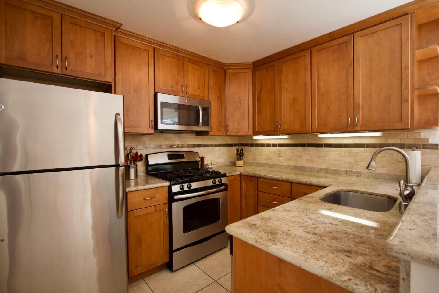 1265 Rosita Road Pacifica, CA 94044 - Photo 3 of 15 a kitchen with a refrigerator sink and stove