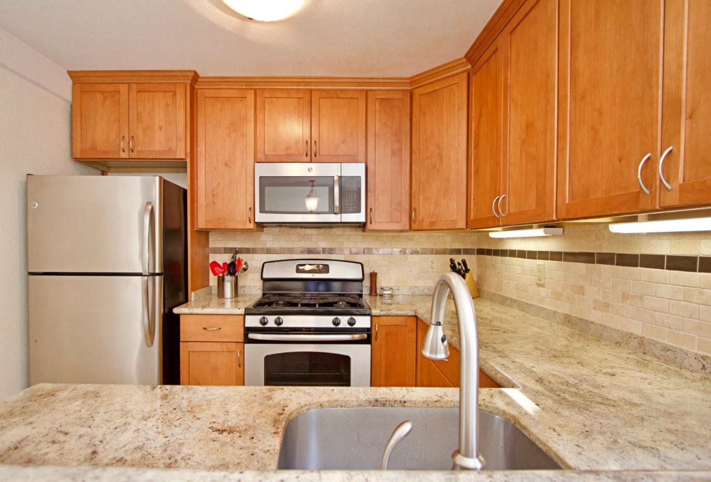 1265 Rosita Road Pacifica, CA 94044 - Photo 4 of 15 a kitchen with a refrigerator stove and microwave
