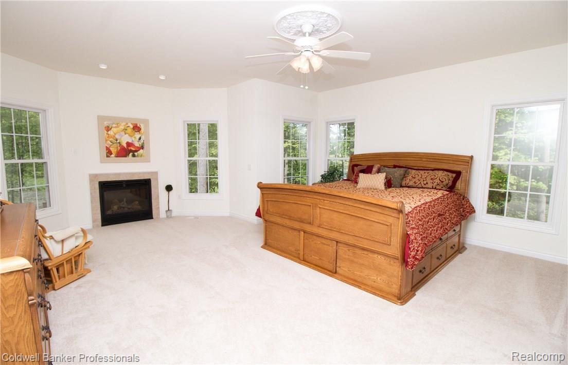 11020 Hensell Road Holly, MI 48442 - Photo 25 of 93 Master Bedroom with a gas fireplace and plenty of natural light. 2 walk-in closets.