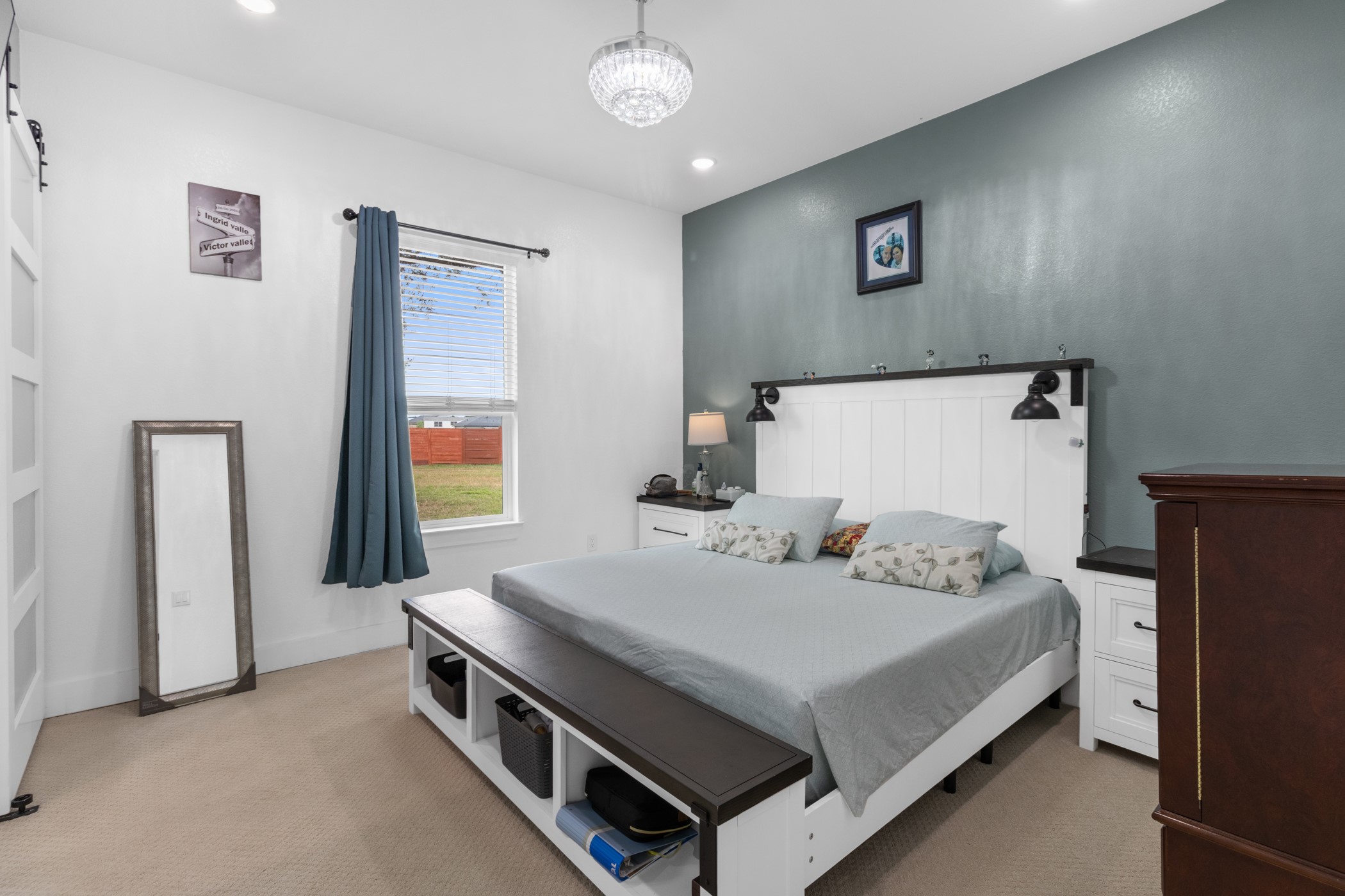123 Zacate Street Elgin, TX 78621 - Photo 10 of 33 Carpeted room featuring a window with blinds, white walls, and a contrasting accent wall