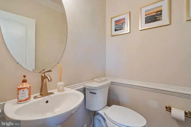 a bathroom with a toilet a sink and mirror