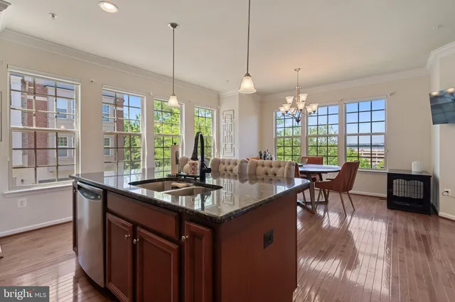 a kitchen with center island and windows