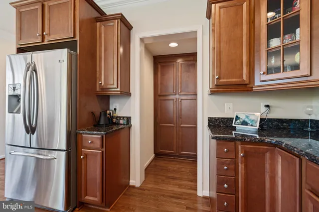 a kitchen with stainless steel appliances granite countertop a refrigerator and a stove top oven
