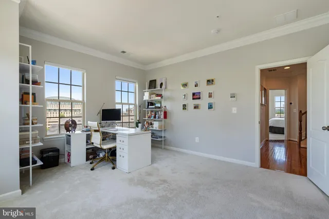a view of a livingroom with workspace and a window