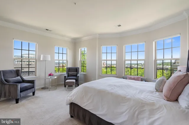 a bedroom with a bed chair and window