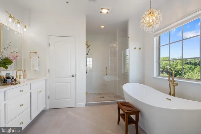 a bathroom with a tub shower and window