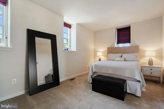 a spacious bedroom with a bed and cabinets