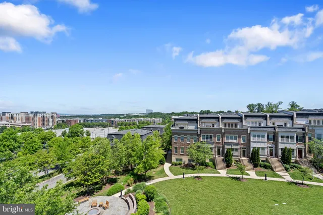 a roof deck with table and chairs