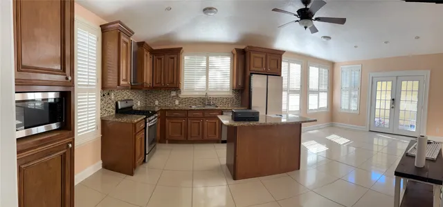 a kitchen with a refrigerator a stove top oven a sink and dishwasher