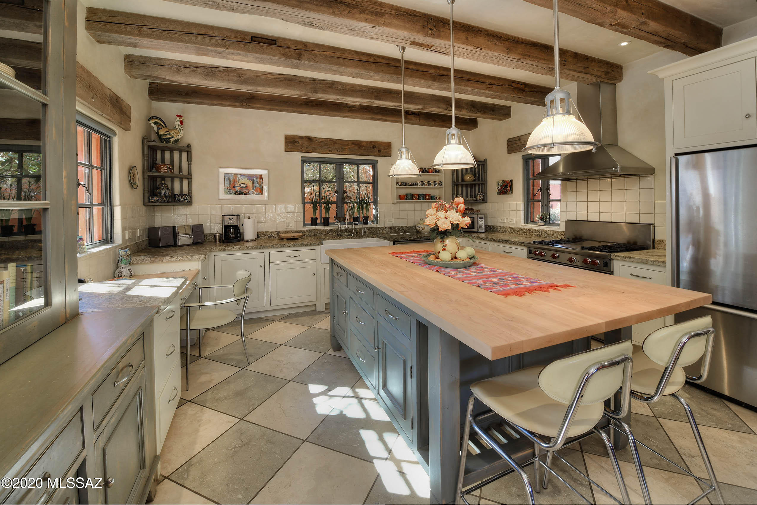 360 Harshaw Creek Road Patagonia, AZ 85624 - Photo 15 of 50 a kitchen with a stove a refrigerator and wooden cabinets