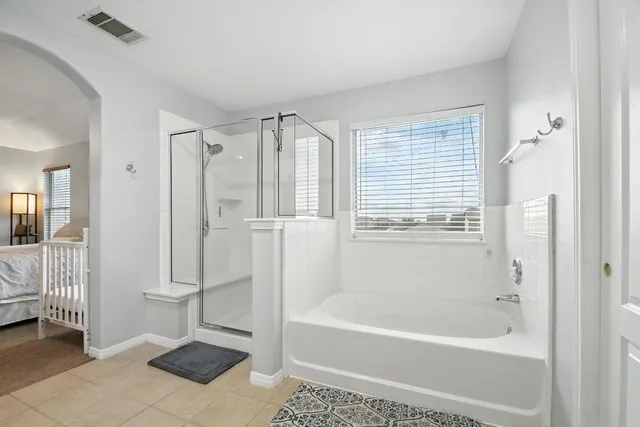 a bathroom with a bathtub and a shower
