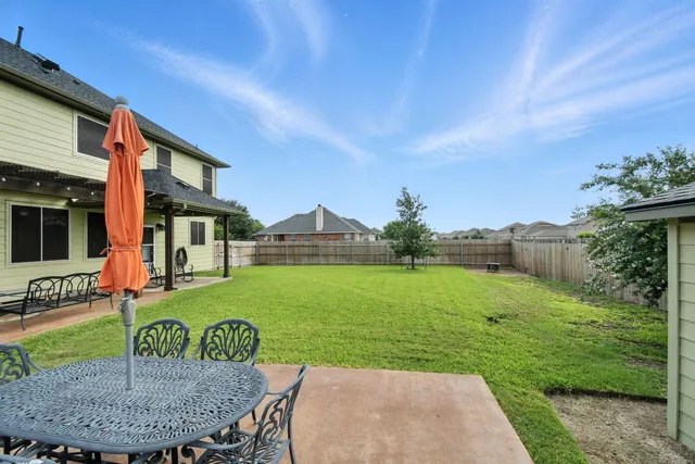 a view of a porch with chairs and backyard