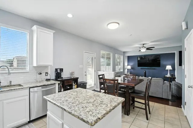 a open kitchen with stainless steel appliances kitchen island granite countertop a sink and cabinets