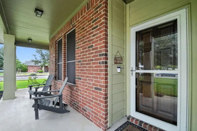 a balcony with table and chairs