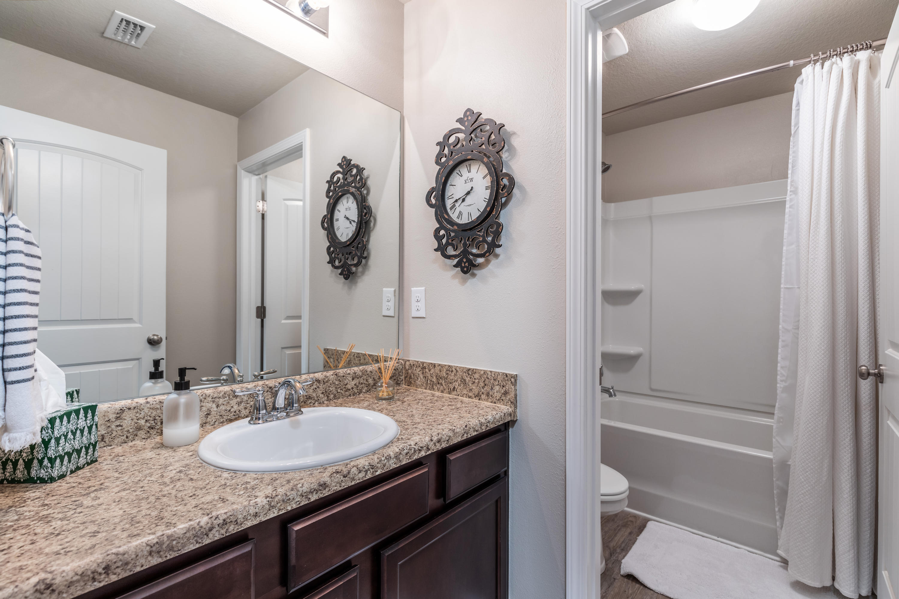321 Fanny Ann Way Freeport, FL 32439 - Photo 19 of 38 a bathroom with a granite countertop sink a toilet and shower