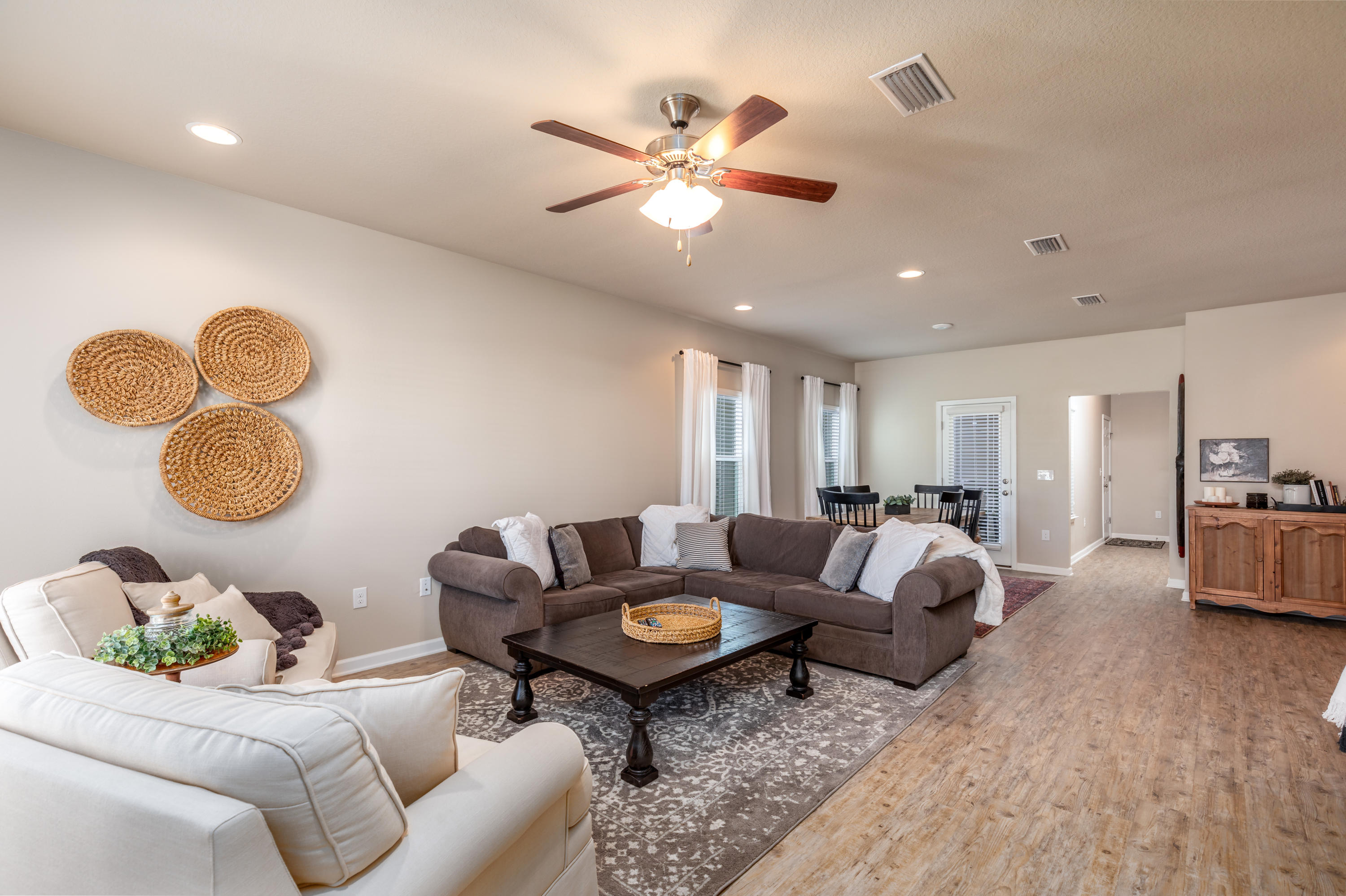 321 Fanny Ann Way Freeport, FL 32439 - Photo 4 of 38 a living room with furniture a chandelier and a rug