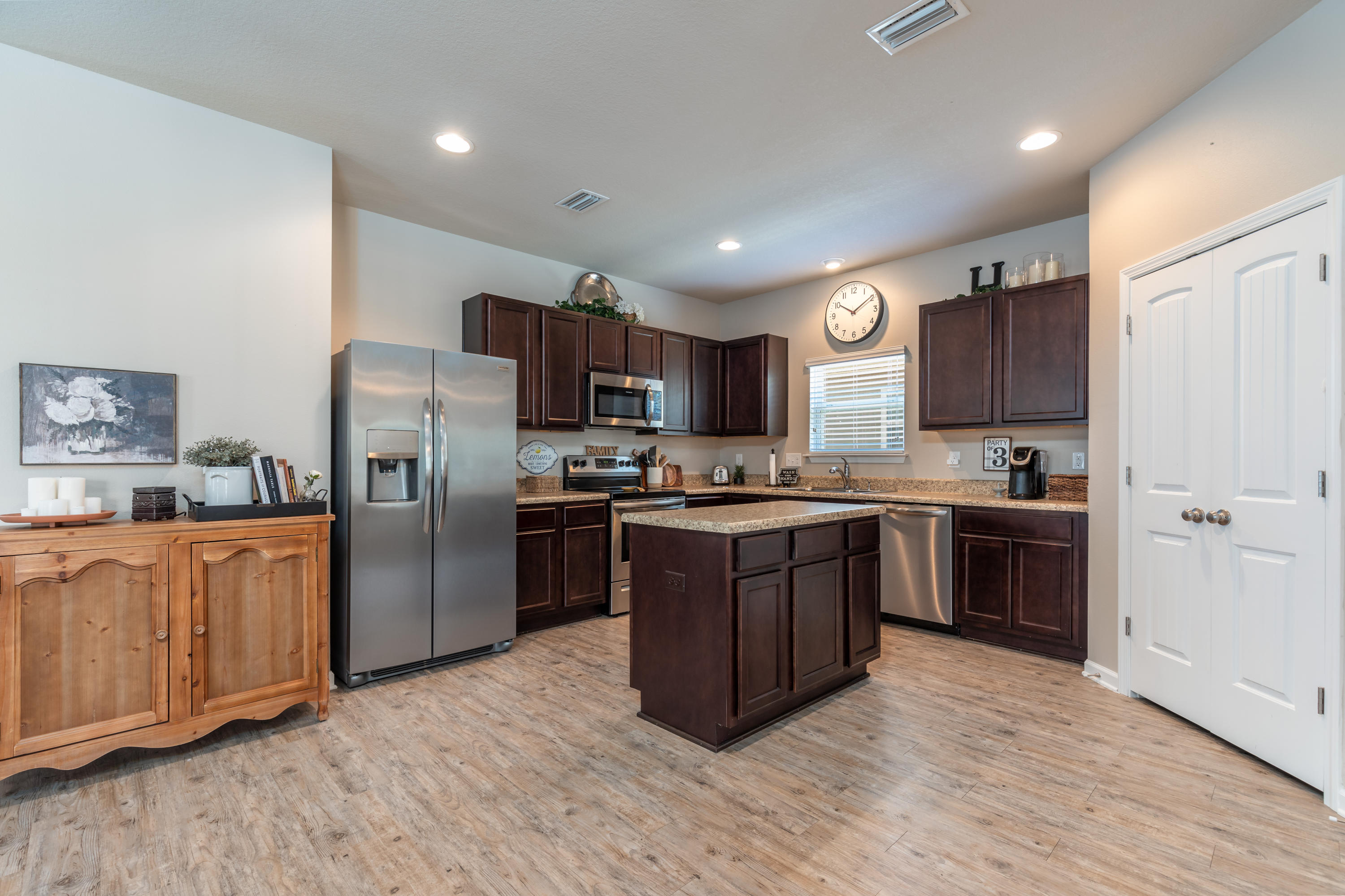321 Fanny Ann Way Freeport, FL 32439 - Photo 8 of 38 a large kitchen with stainless steel appliances granite countertop a refrigerator stove and a sink