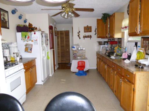 15423 Maple Lane Markham, IL 60428 - Photo 8 of 16 a kitchen that has a lot of cabinets and refrigerator