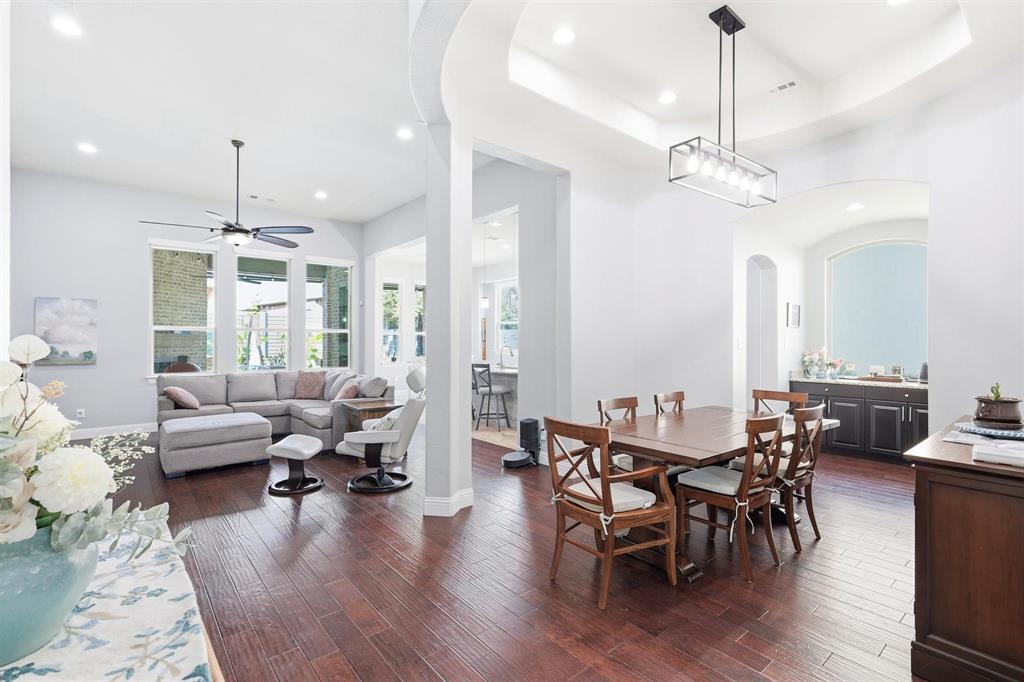 117 Birdcall Lane Argyle, TX 76226 - Photo 12 of 40 Dining area featuring recessed lighting, dark wood-style flooring, a tray ceiling, arched walkways, and ceiling fan