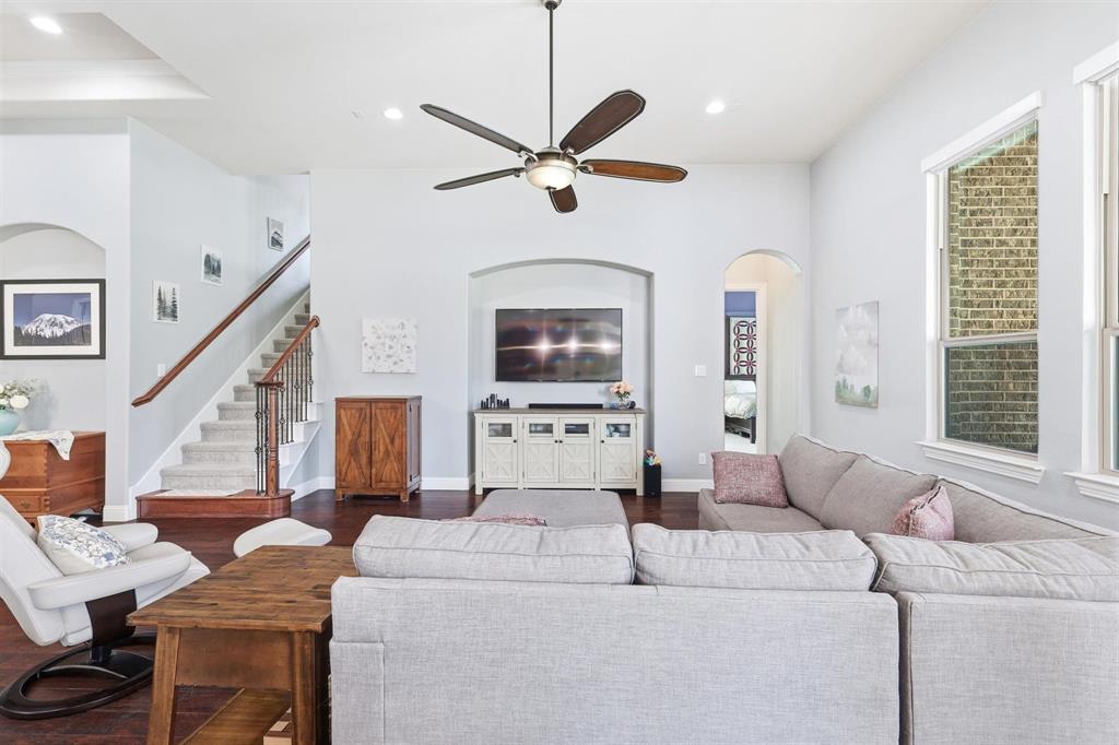117 Birdcall Lane Argyle, TX 76226 - Photo 17 of 40 Living room with arched walkways, ceiling fan, dark wood finished floors, stairs, and recessed lighting