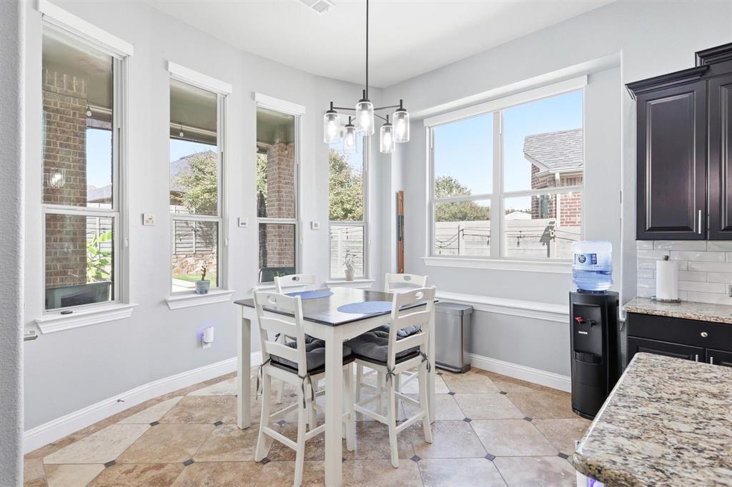 117 Birdcall Lane Argyle, TX 76226 - Photo 23 of 40 Dining room featuring light tile patterned flooring and a chandelier