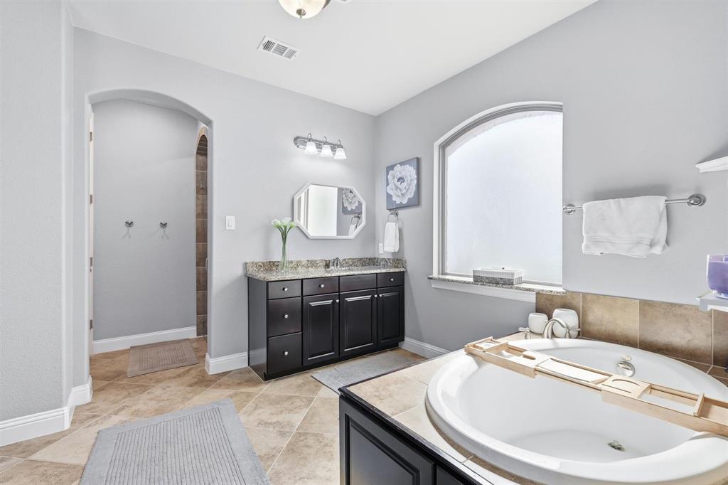 117 Birdcall Lane Argyle, TX 76226 - Photo 29 of 40 Bathroom featuring vanity, a garden tub, and light tile patterned floors